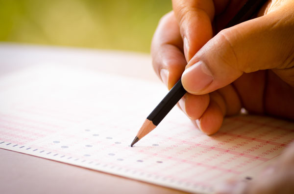 student taking a test on a scantron form