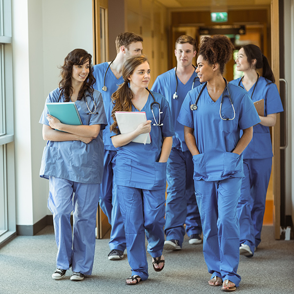 group of nurses walking together talking