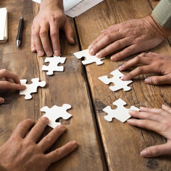 people working to put together a puzzle