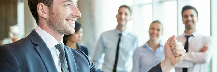 Cheerful leader motivating his business team