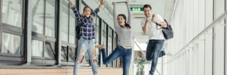 students jumping in a school hallway