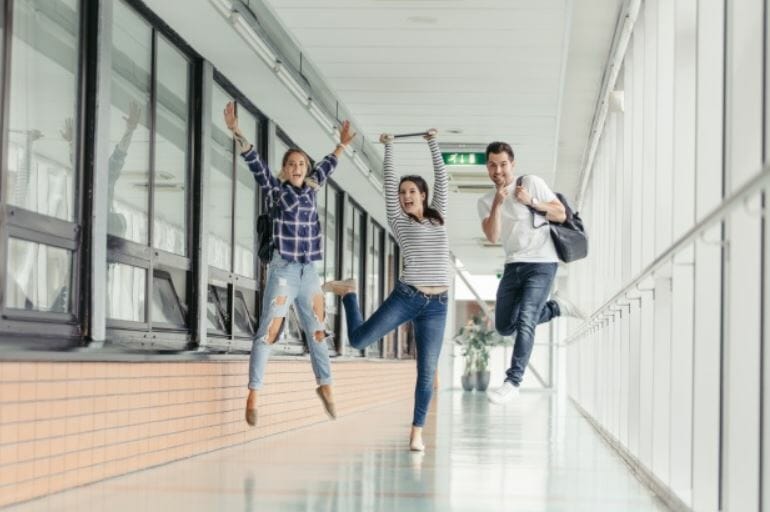 students jumping in a school hallway