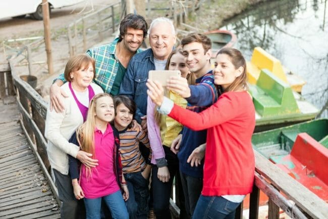 multiple generation of a family at a boat dock taking a picture