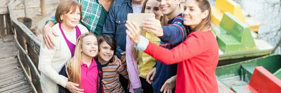 multiple generation of a family at a boat dock taking a picture