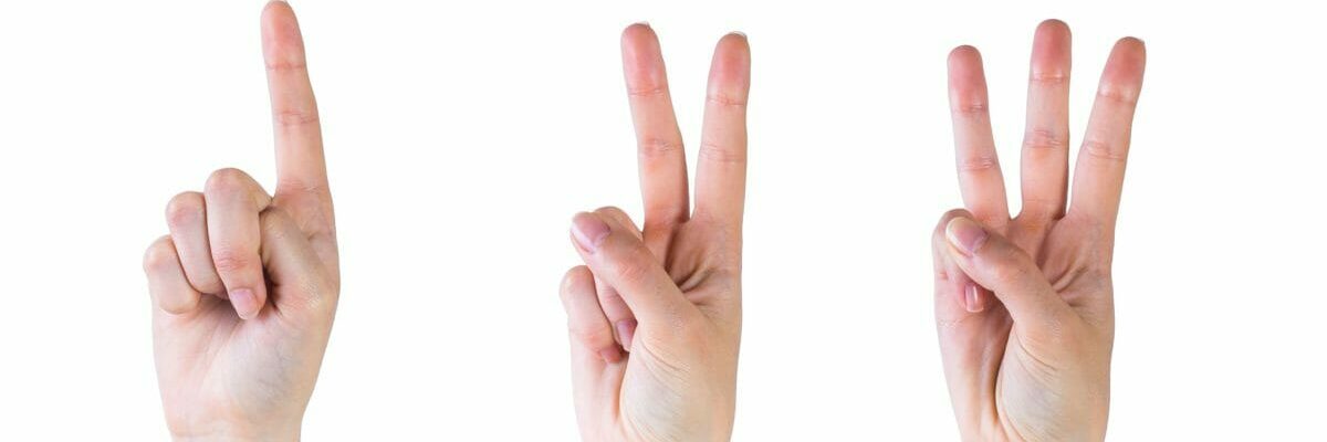 three hands holding one, two and three fingers