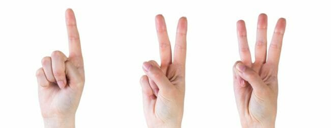 three hands holding one, two and three fingers