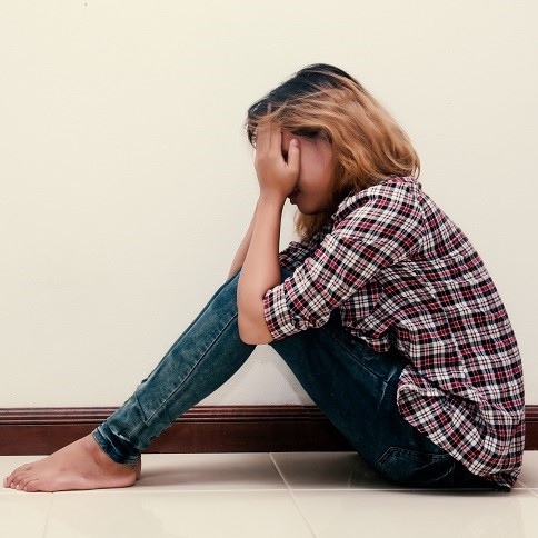 female student with head in her hands crying