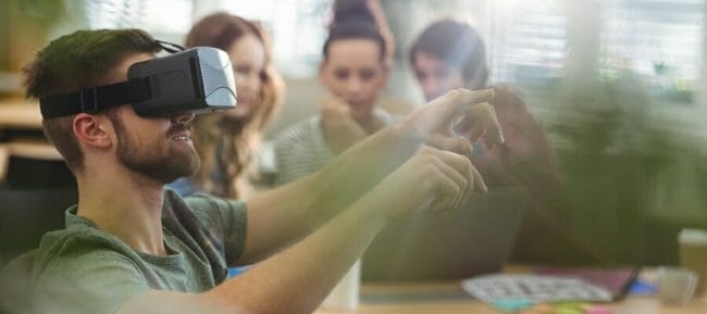 Male business executive using virtual reality headset Male business executive using virtual reality headset