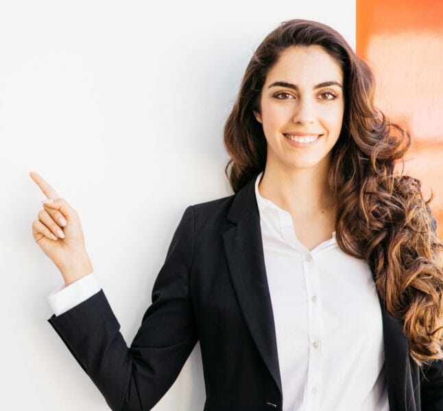 Business woman in suit pointing