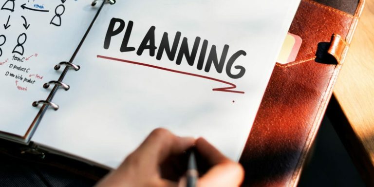 Woman writing and planning business strategy