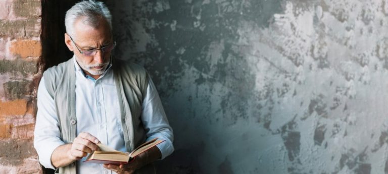 senior faculty member reading a book