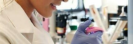Close up of a female student using biomedical tool