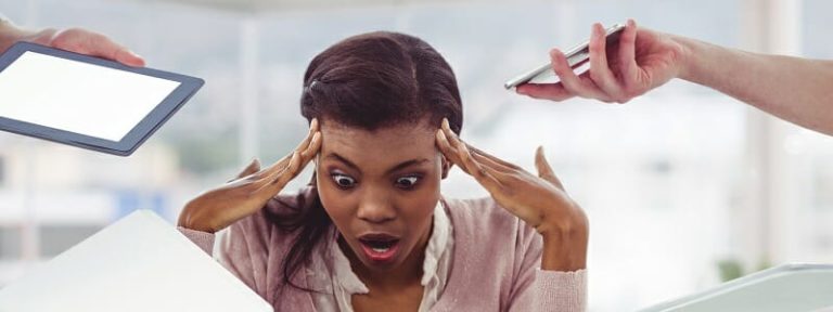 Conception image of a stressed businesswoman with electronic devices