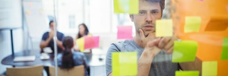 Close-up of male executive reading sticky notes