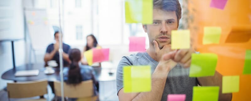 Close-up of male executive reading sticky notes
