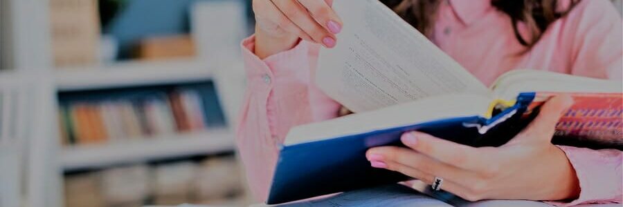 woman flipping through a textbook