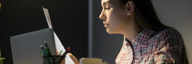 Female worker analyzing company financial reports