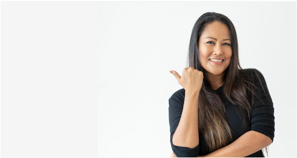 Woman with her finger pointing back at the background