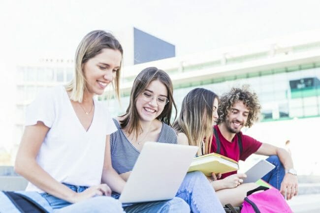 group of students outside on their computers