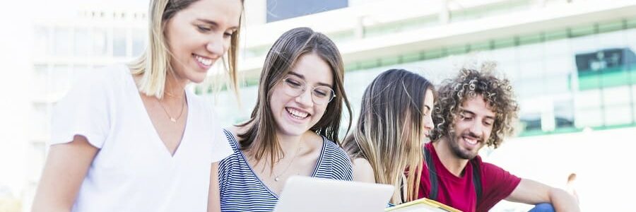 group of students outside on their computers