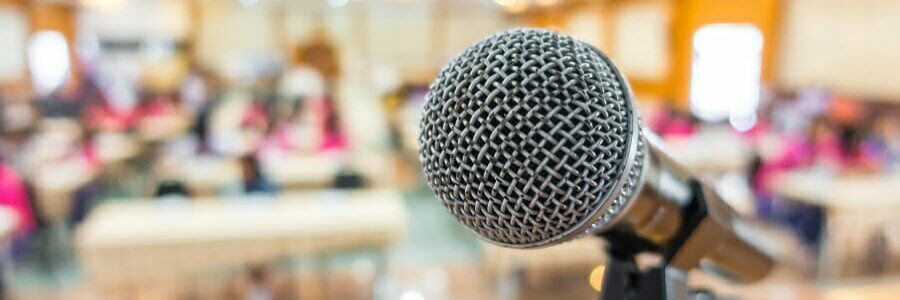 Black microphone in conference room .