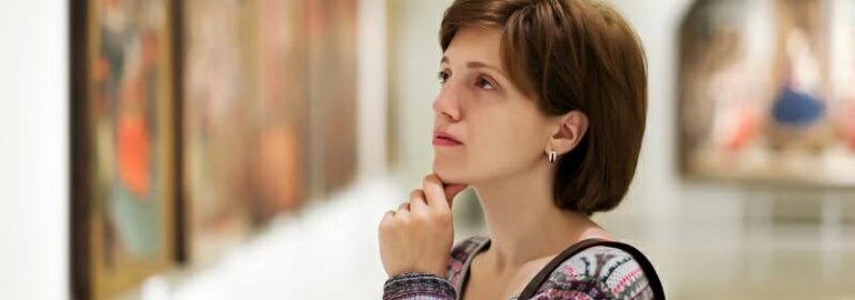 visitor looking pictures in art gallery