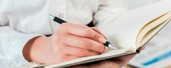 612336-PNHPSS-461a Close up of student taking notes in a notebook
