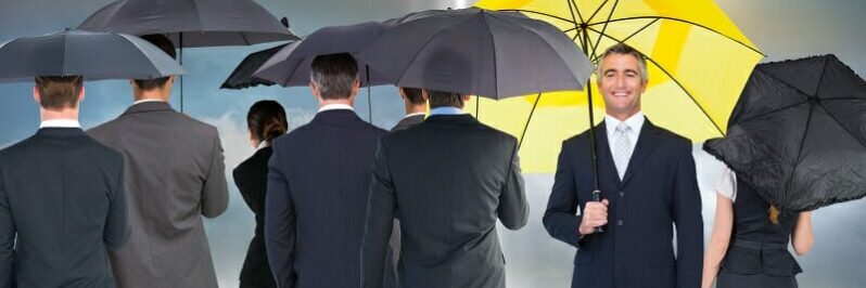 Older male with a yellow umbrella standing out in a crowd
