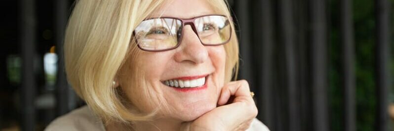 Closeup of Happy Attractive Senior Woman in Cafe