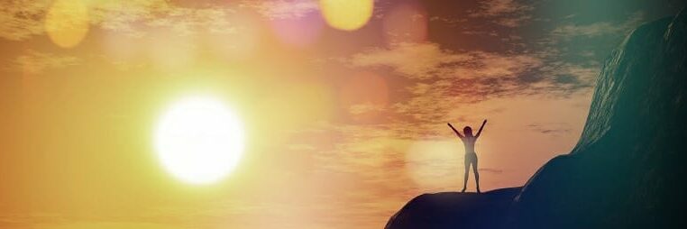 3D female on top of a cliff against a sunset sky
