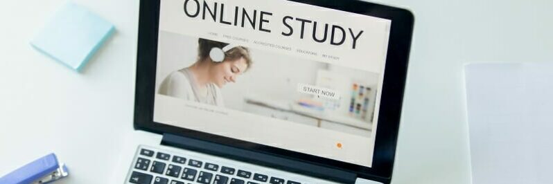 Hands working with a laptop, title online study on screen Hands working with a laptop, title online study on screen