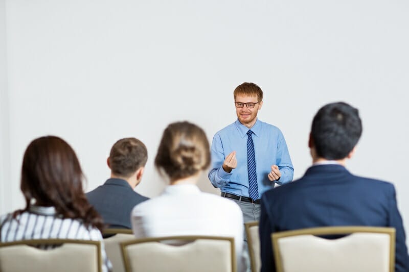 Young Speaker Gesturing and Smiling