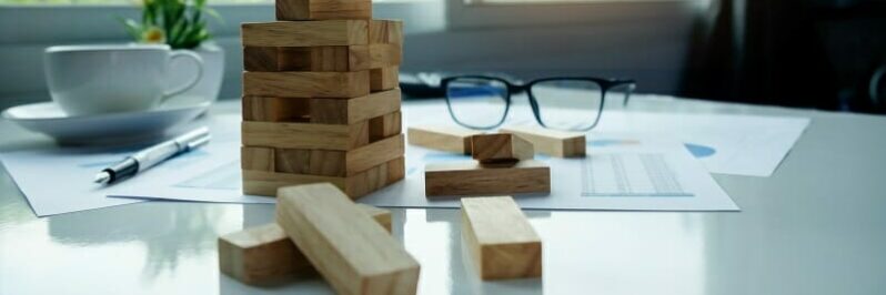 587a Desk with wooden blocks among loose business documents