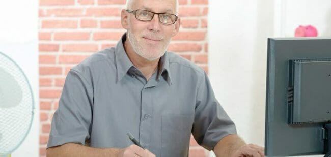 Senior businessman working on computer Senior businessman working on computer