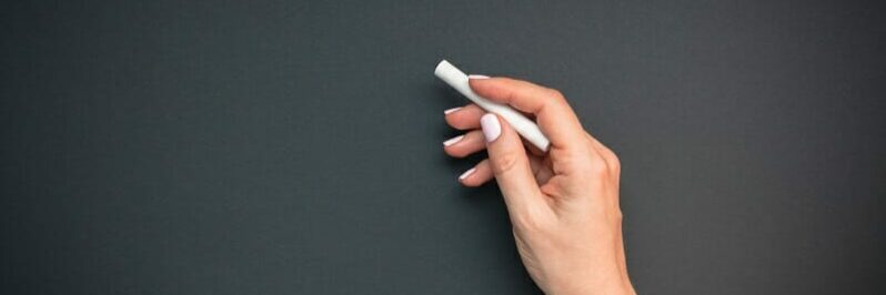 Teacher hand with piece of chalk Teacher hand with piece of chalk