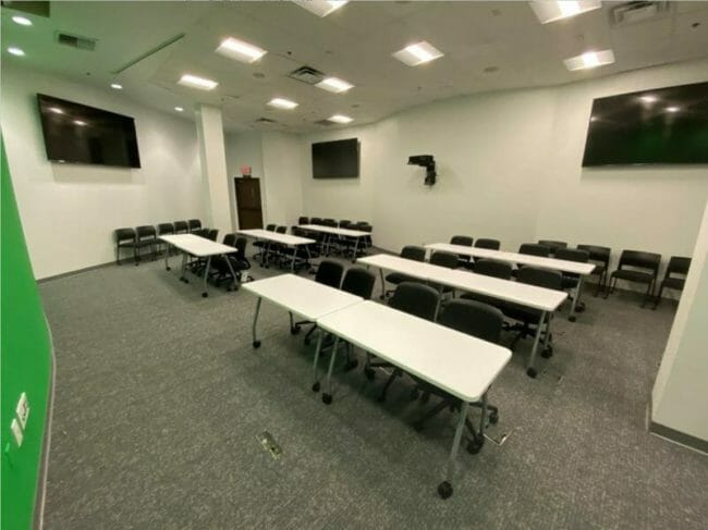 Empty classroom with rows of table and chairs inside Bartlett-Flex building
