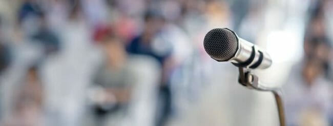 Microphone in front of a large audience