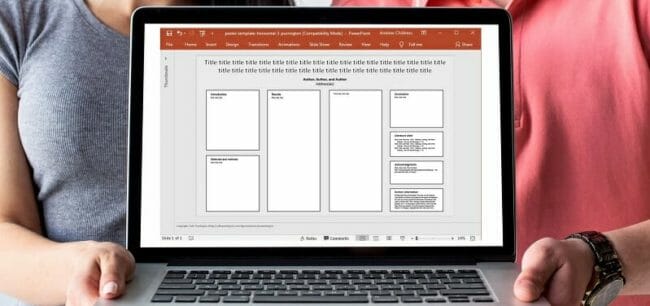 2484527b Two people holding a laptop with an organizational chart displayed on screen