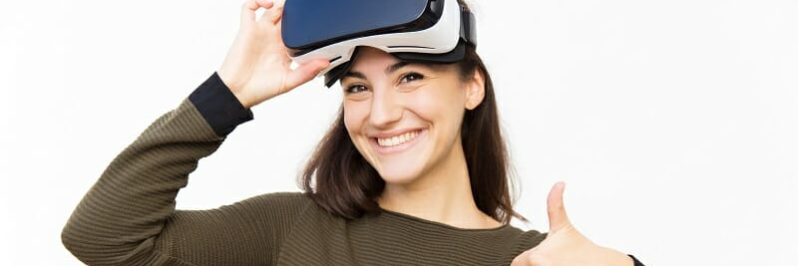 Smiling happy student taking off VR headset Smiling happy student taking off VR headset