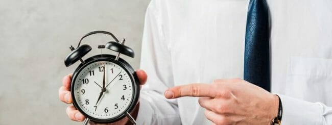 Man pointing to a clock
