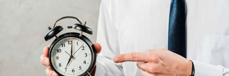 Man pointing to a clock