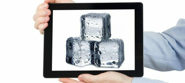 Man holding iPad displaying a photograph of ice cubes