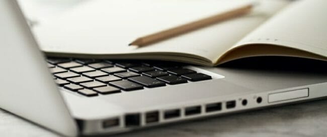 Closeup of Workspace with Modern Creative Laptop, Cup of Coffee