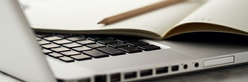 Closeup of Workspace with Modern Creative Laptop, Cup of Coffee