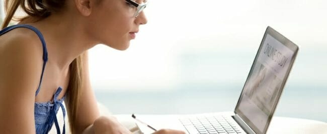 Female student studying online with laptop Female student studying online with laptop