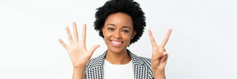 African american woman with blazer over isolated white background counting seven with fingers African american woman with blazer over isolated white background counting seven with fingers