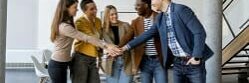 Group of positive businesspeople standing together in the office