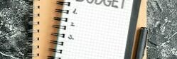 top-view-budget-written-note-notepad-with-pen-dark-surface-student-color-copybook-school-money-gray-business